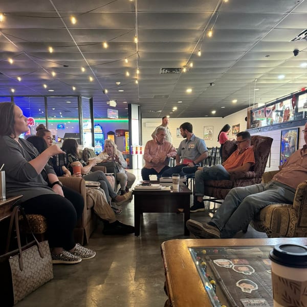 Customers relaxing in armchairs and conversing in the casual, brightly lit interior of Decades Family Restaurant.