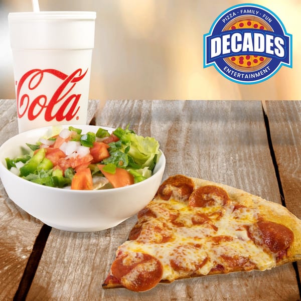 Decades Family Restaurant pepperoni pizza slice, side salad, and a Coca-Cola drink on a wooden table.