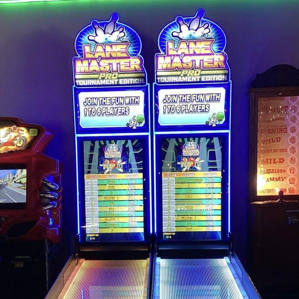 Two glowing blue Lane Master arcade bowling games stand ready for play at Decades Family Restaurant.
